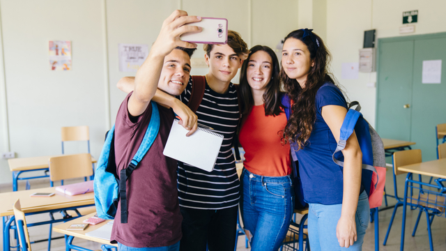 group friends taking selfie classroom