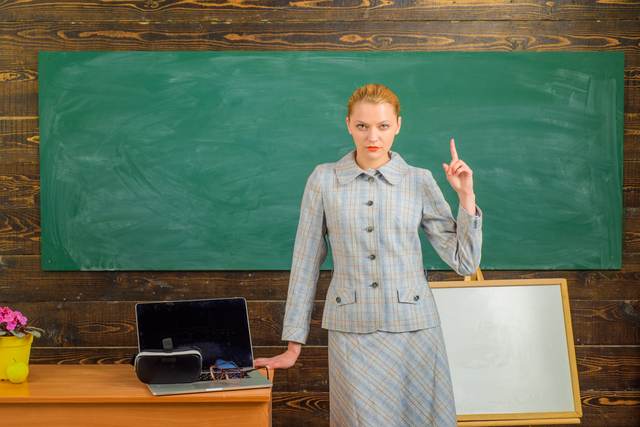 Scholarship. Back to school. Serious teacher in classroom. Education concept. School. Smiling teacher in suit. Business concept
